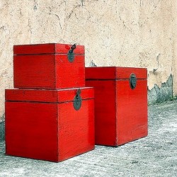 Nest of three red lacquered trunks