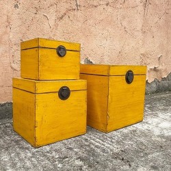 Nest of three yellow lacquered trunks