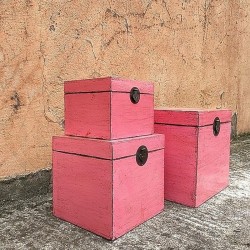 Nest of three pink lacquered trunks